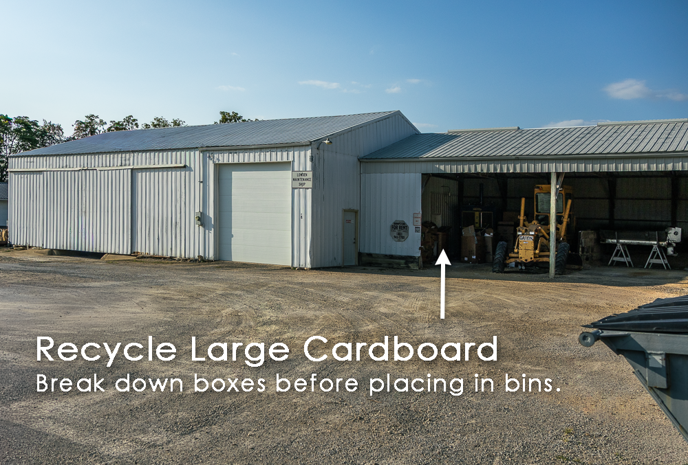 A photo of the city maintenance building with an arrow pointing to where recycled boxes should be put