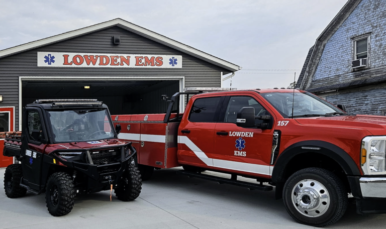 EMS truck and side by side in front of the building