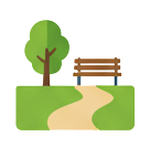 A grassy park with a tree and bench